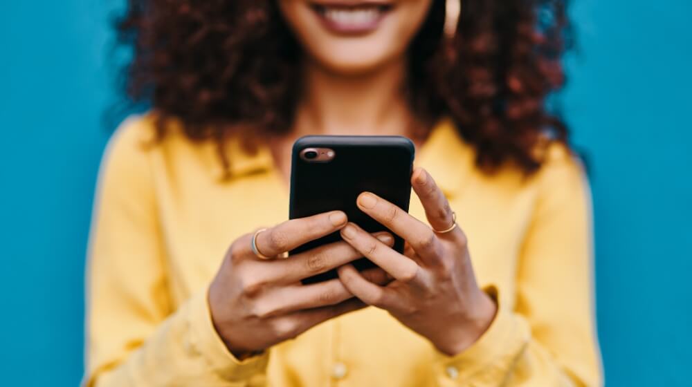 smiling woman holding phone